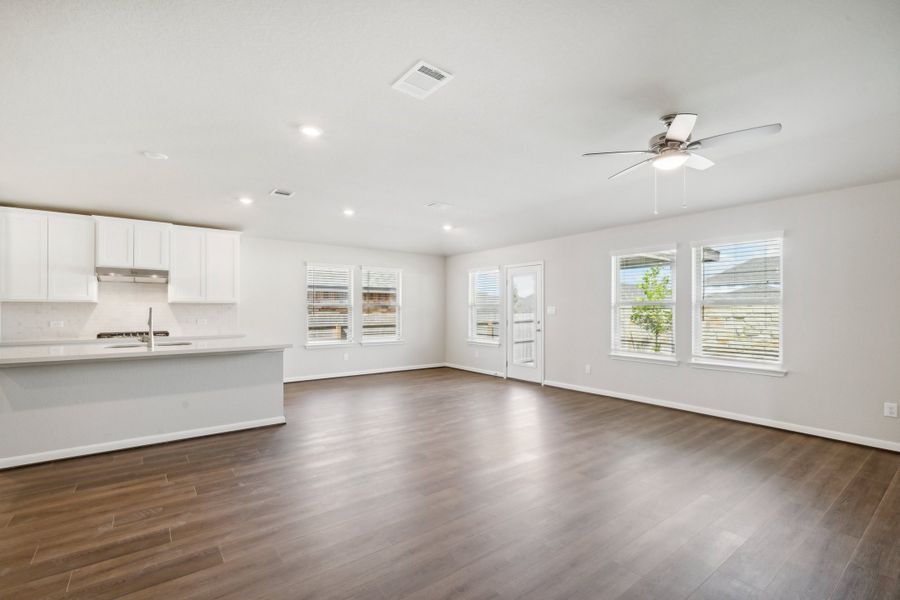 Kitchen, dining room, and living room in the Fitzhugh floorplan in a Meritage Homes community.