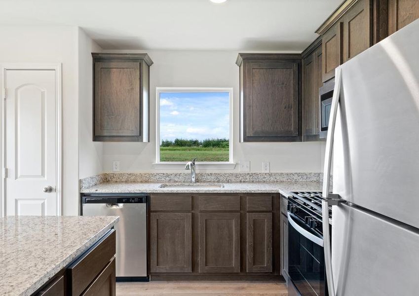 The kitchen has gorgeous wood cabinetry.