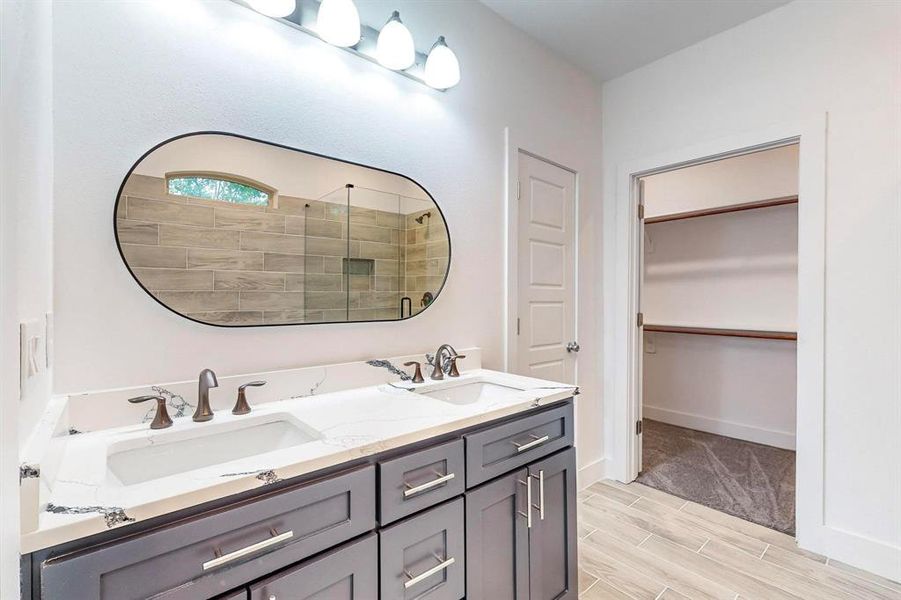 Bathroom featuring walk in shower and vanity