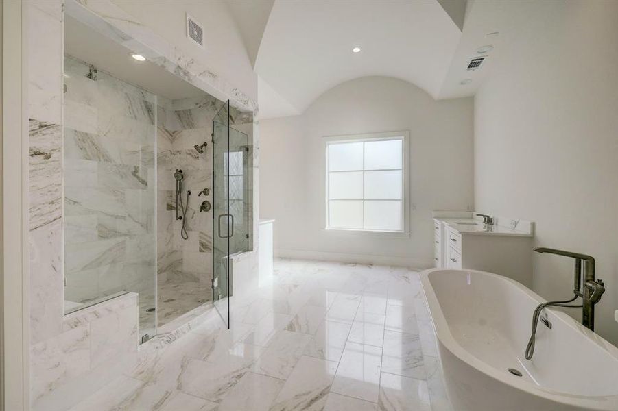 You will love this marble shower with dual shower heads and frameless glass shower doors! With the large frosted window, natural light flows abundantly into the room.