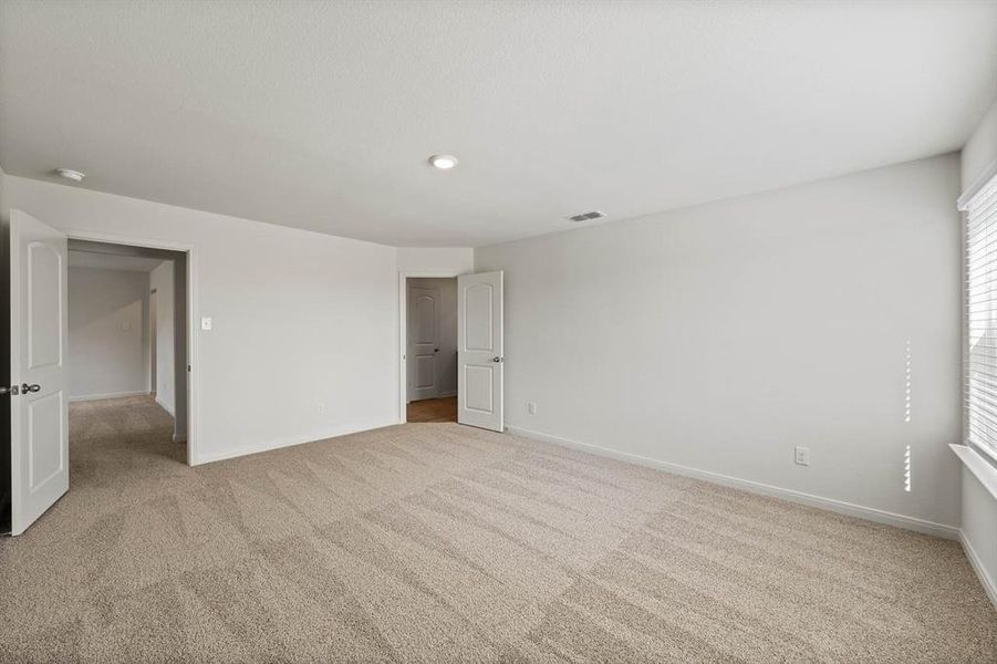 Bedroom featuring light colored carpet