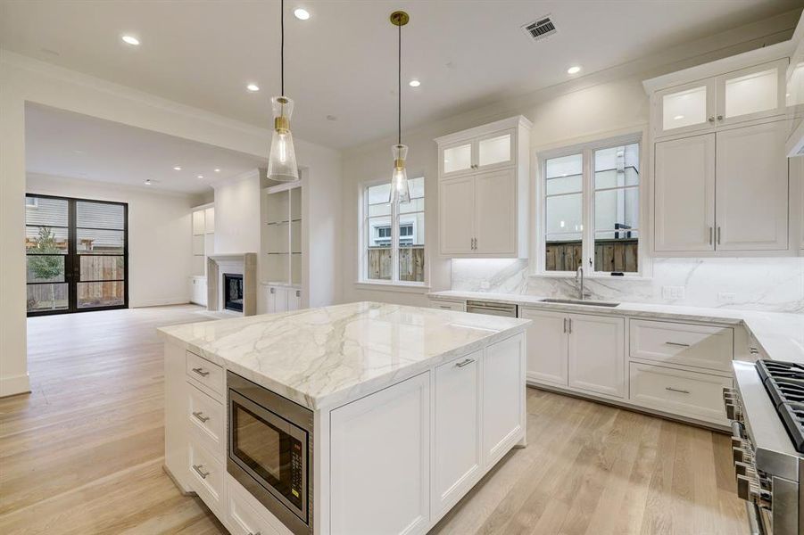 This beautiful marble top island/breakfast bar features storage options on all 4 sides as well as a built in microwave!