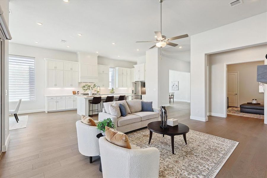 Living room with light hardwood / wood-style flooring and ceiling fan