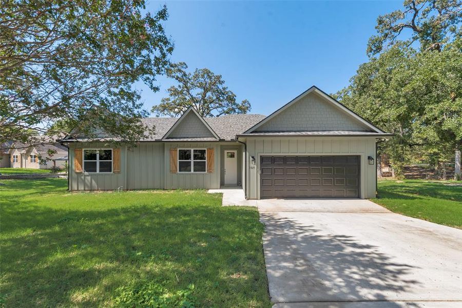 Ranch-style home with a garage and a front yard