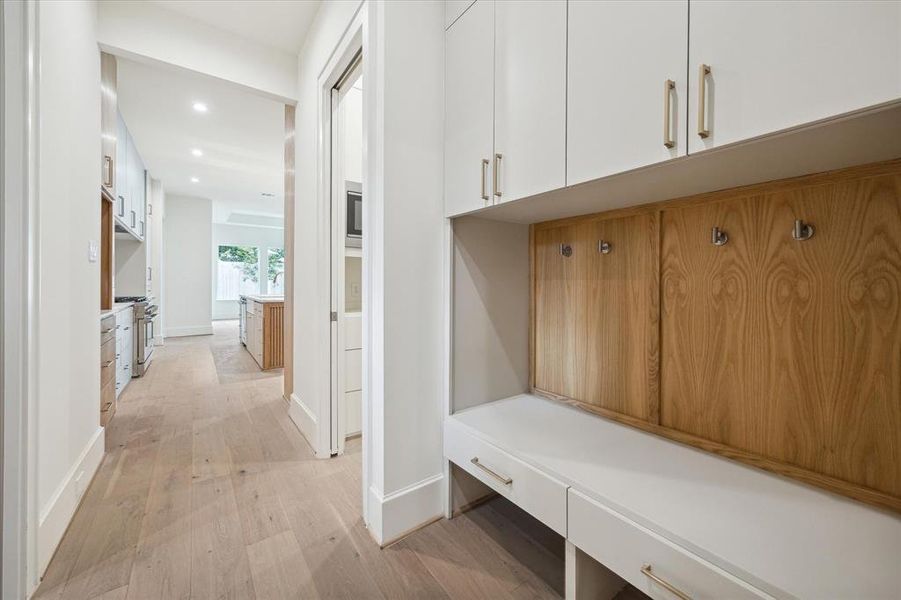 Just in from the garage, the mud room offers an intentional place to drop everything. The laundry room on the left opens to the primary suite's closet. The two-car garage has an EV charging station.