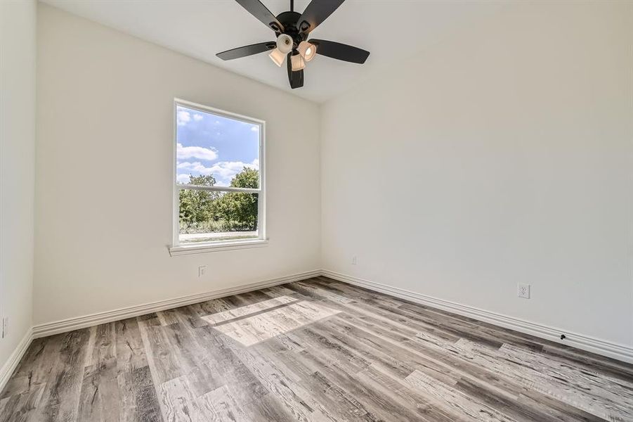 Spare room with light hardwood / wood-style floors and ceiling fan