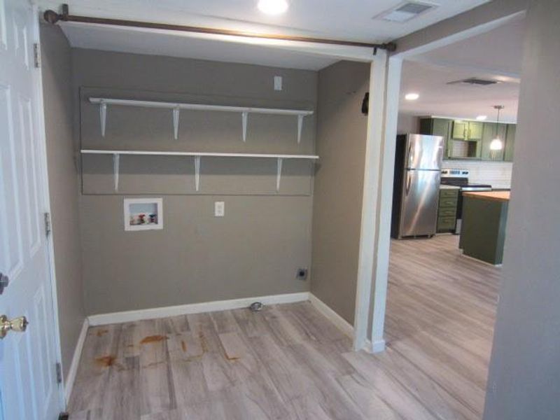 Laundry room featuring hookup for an electric dryer, washer hookup, and light wood-type flooring