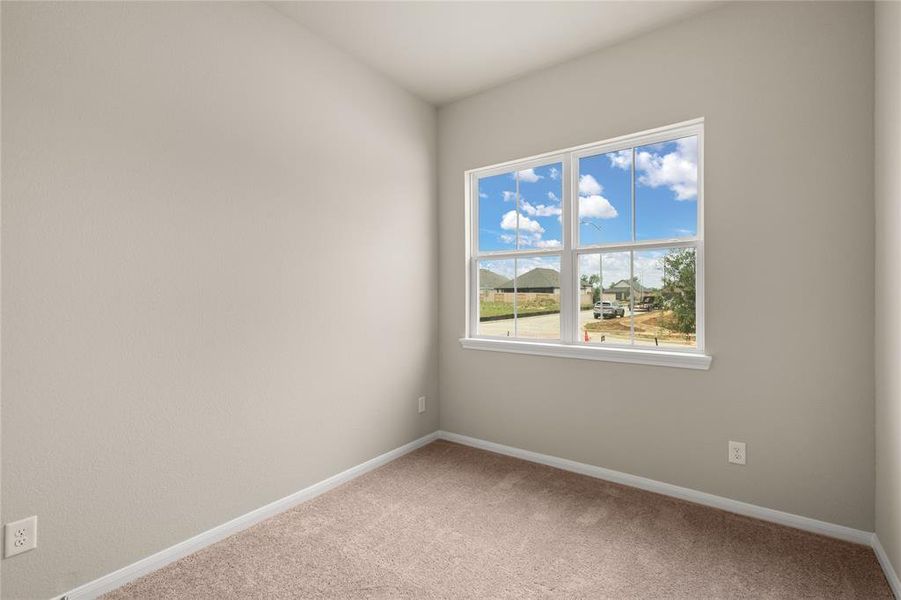 Your secondary bedroom features plush carpet, fresh paint, closet, and a large window that lets in plenty of natural lighting.