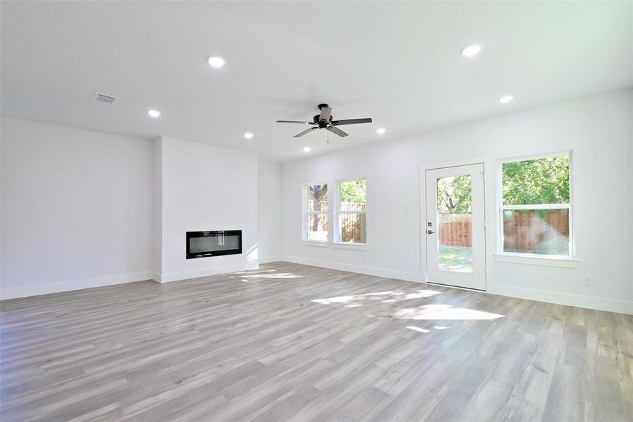 Unfurnished living room with light hardwood / wood-style flooring and ceiling fan