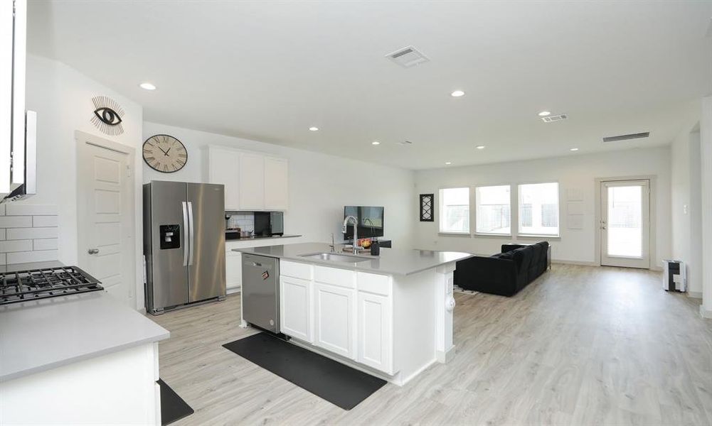 Island kitchen that opens to the family room.