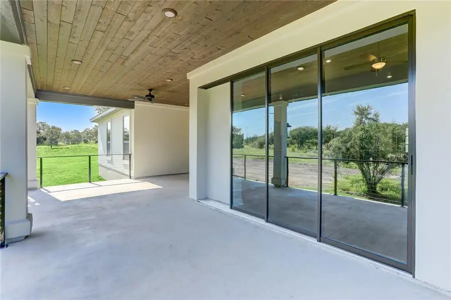 Enjoy the picturesque, Texas Hill Country views from the covered patio of this home that comes complete with a built-in outdoor kitchen and ceiling fan.