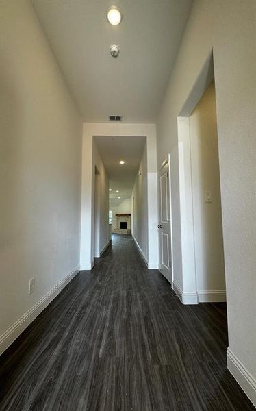 Corridor featuring dark wood-type flooring