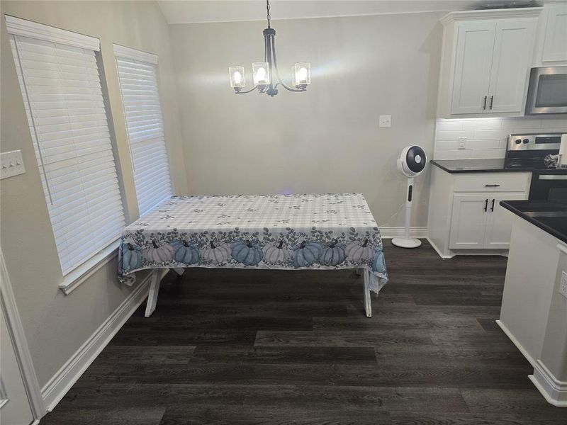 Dining Room featuring a notable chandelier and dark hardwood / wood-style floors