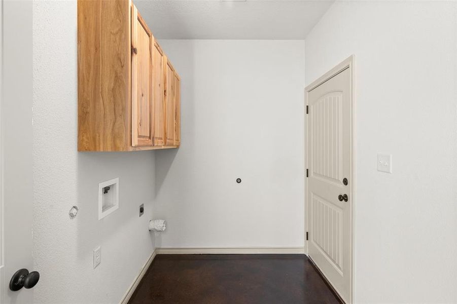 Washroom with washer hookup, hookup for an electric dryer, and cabinets