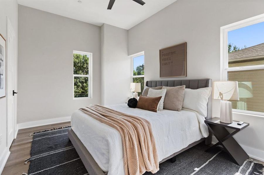 Bedroom with dark wood-type flooring and ceiling fan