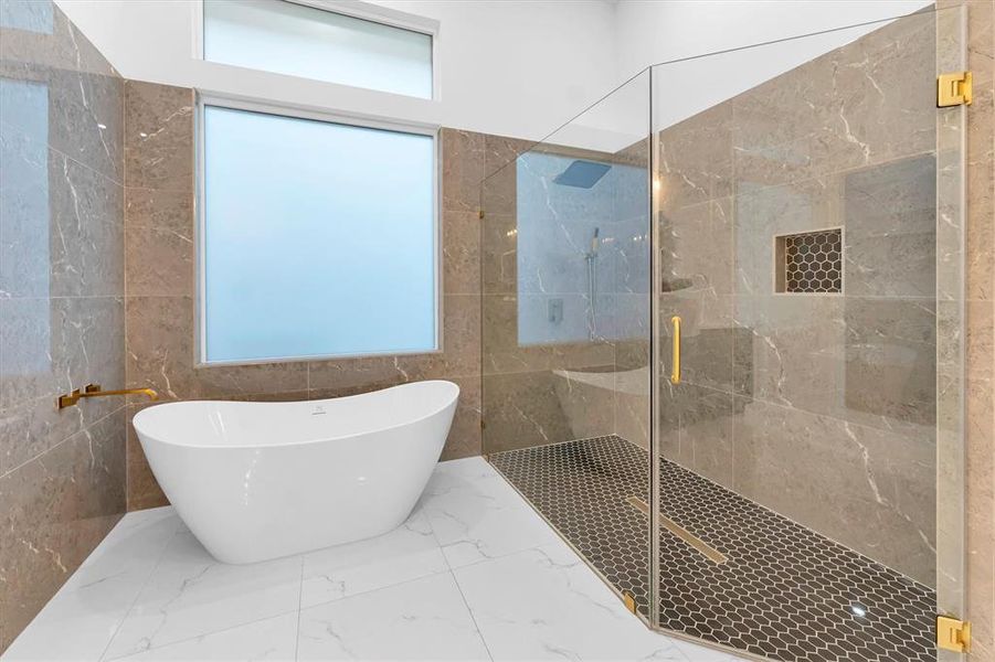 Relax in the luxury soaking tub or have an invigorating shower in the large walk-in, frameless glass shower with rain shower head, hand held shower head and two wall insets for soap and shampoo.