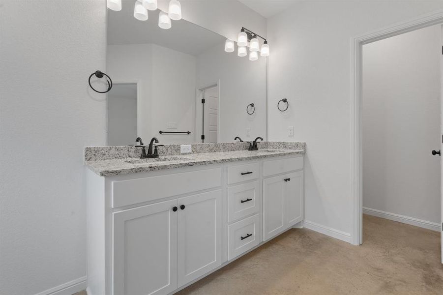 Bathroom featuring vanity and concrete floors