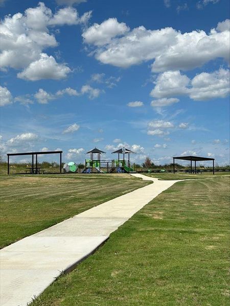 View of community with a playground and a yard