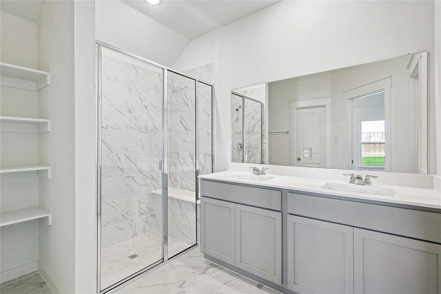 Bathroom with vanity and a shower with door