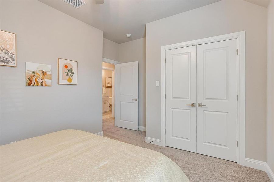 Carpeted bedroom with a closet