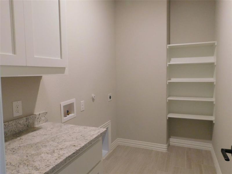 Large utility room with folding table, cabinets & storage