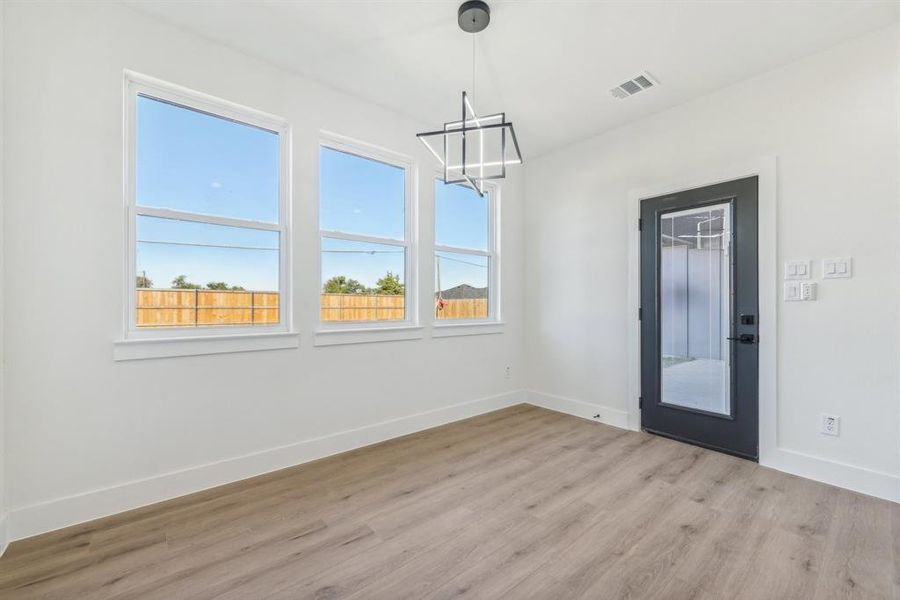 Unfurnished dining area with a healthy amount of sunlight and light hardwood / wood-style flooring