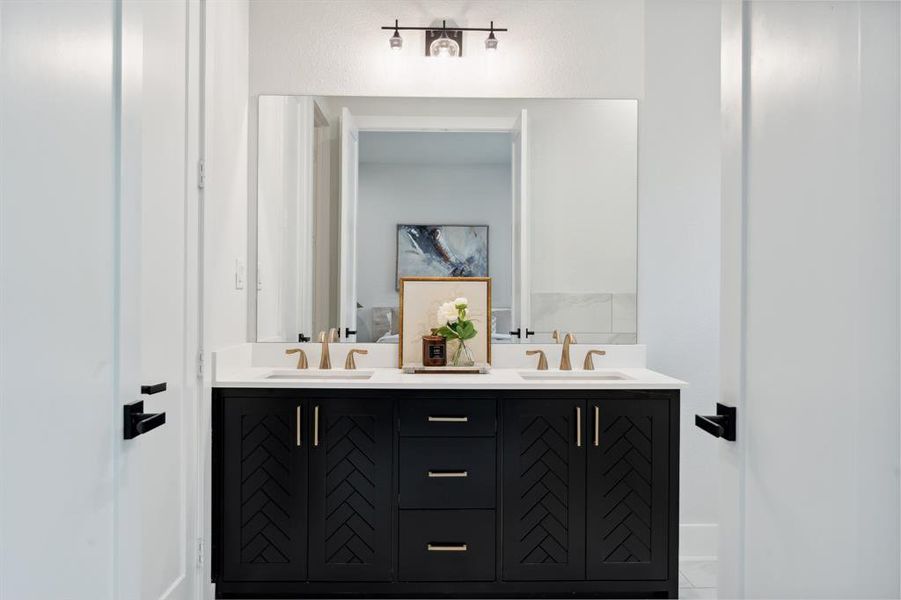 In the primary bathroom, dual vanity sinks and drawers provide plenty of storage.