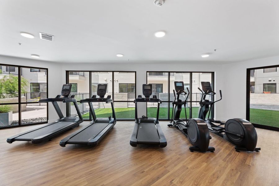 Fitness studio with free weights, cardio equipment, and more