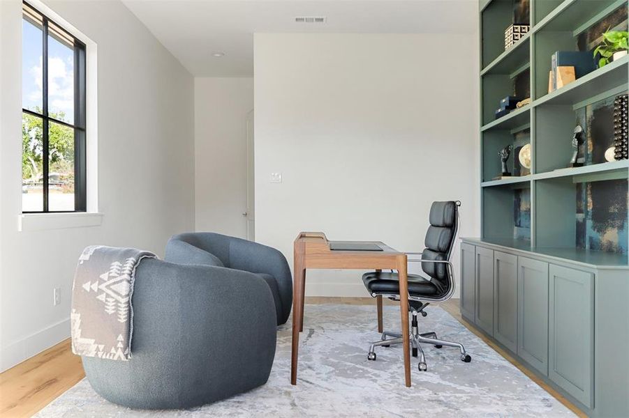 Home office with light hardwood / wood-style floors