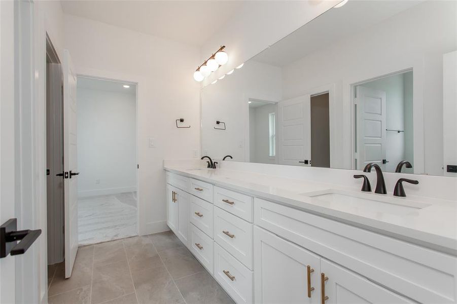 Bathroom with tile patterned floors and double sink vanity