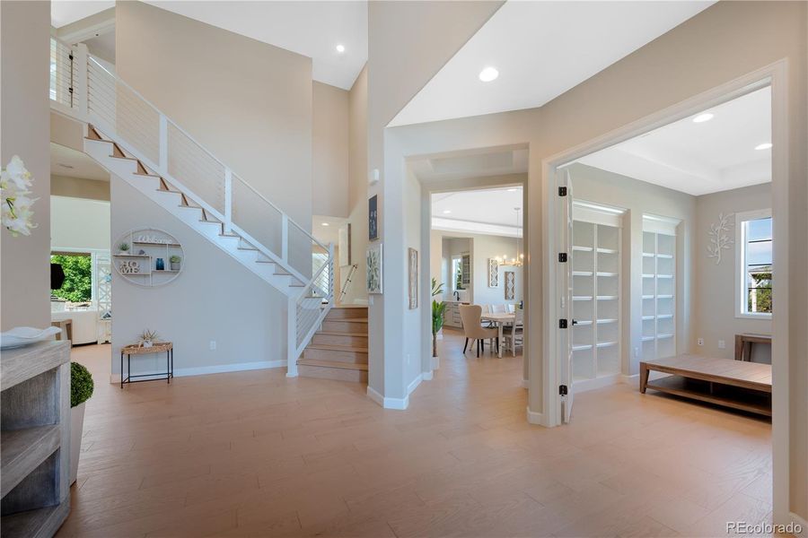 Foyer with Double Staircase and Vaulted Ceilings