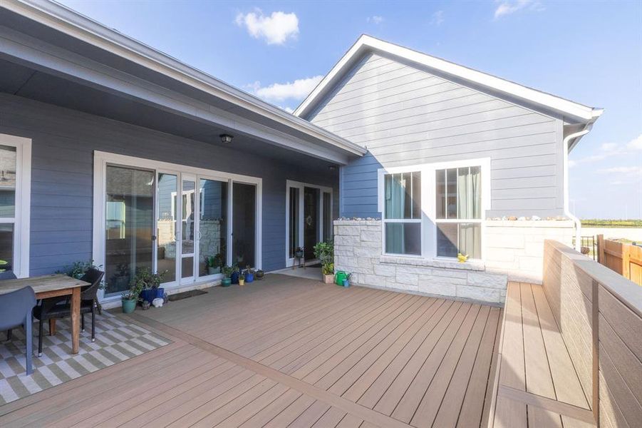 The stunning patio with built-in seating was a $20k upgrade. Facing east, the front door is to your left, next to the sliding glass doors that separate the living room from the patio—with open for seamless indoor/outdoor living and entertaining.