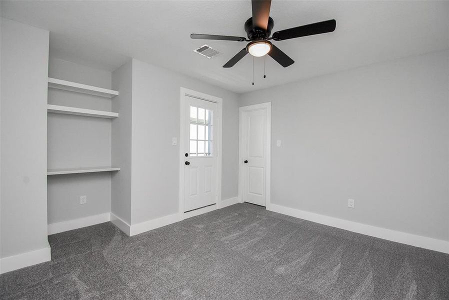 Bedroom with balcony and built-in desk