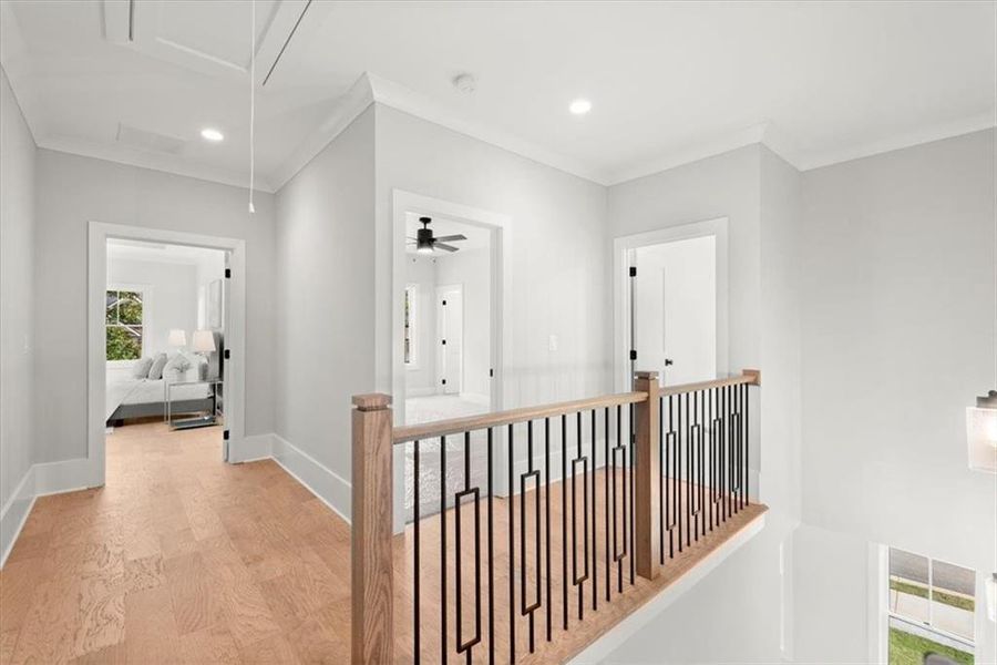 Hall featuring light wood-type flooring and crown molding