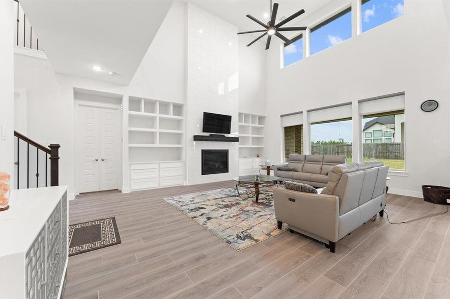 Custom-built cabinets flank a cozy fireplace, adding both storage and charm.