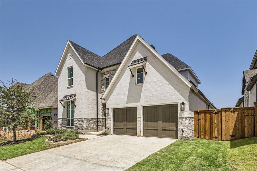 View of front of house with a front yard and a garage