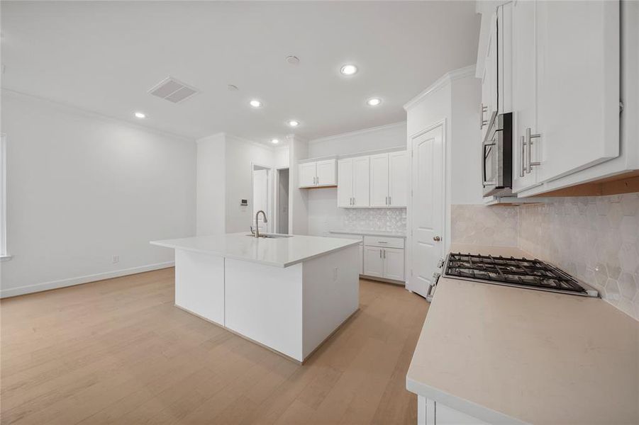 The Gibraltar Kitchen! Featuring quartz countertops, Benedettini custom cabinets, including a pull-out trash can for added convivence and Moen plumbing fixtures. (Sample photos of a completed Gibraltar floor plan. The image may feature alternative selections and/or upgrades.)