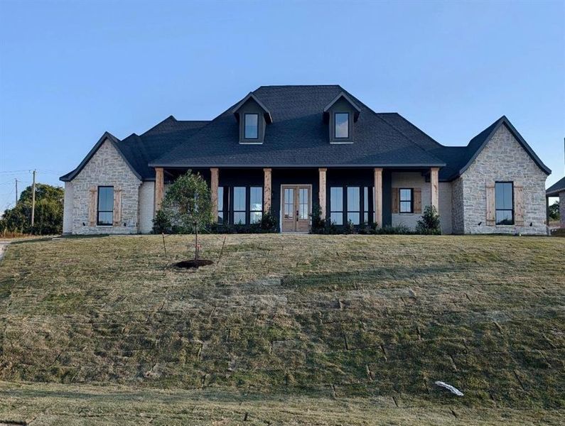 View of front of property with a front yard