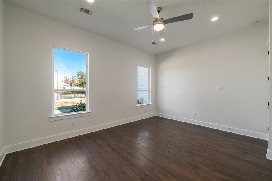 Spare room with dark hardwood / wood-style floors and ceiling fan