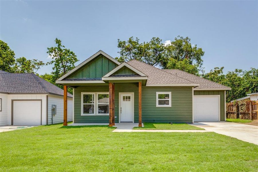 View of front of home featuring a garage and a front yard