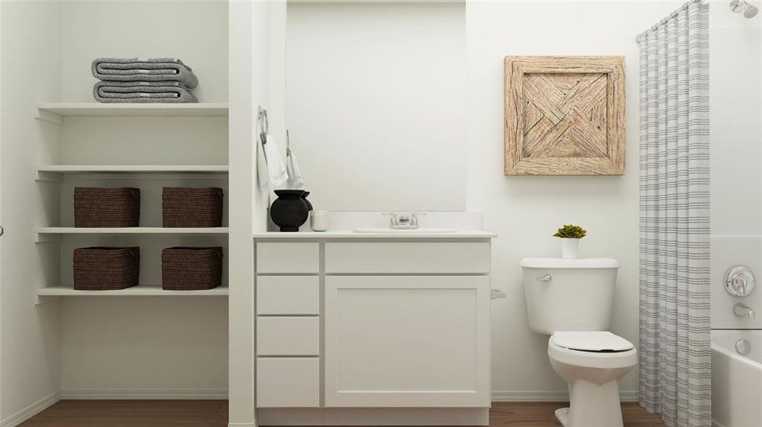 Full bathroom with wood-type flooring, shower / tub combo, vanity, and toilet