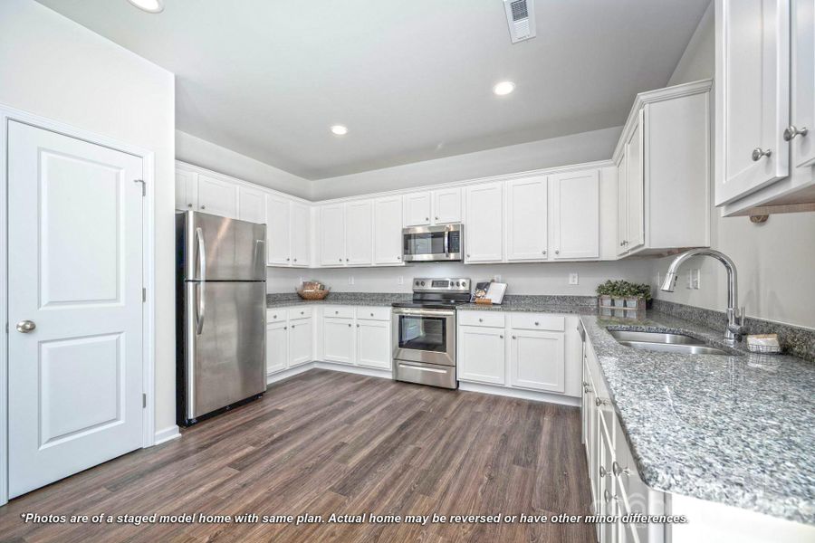 Kitchen with granite countertops, stainless appliances and generous amount of cabinet and counter space
