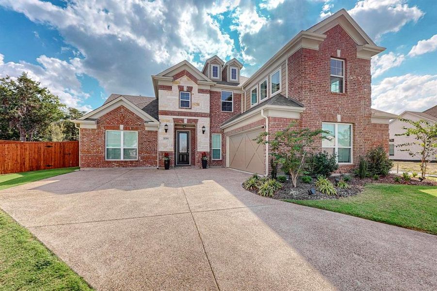 View of front of home with side facing garage and tons of extra parking space