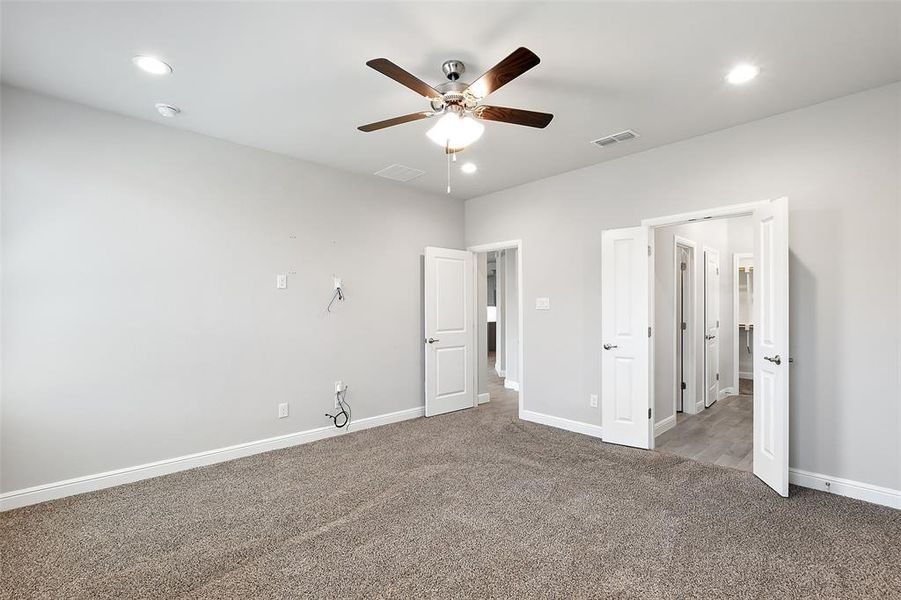 Unfurnished bedroom featuring ceiling fan and carpet flooring