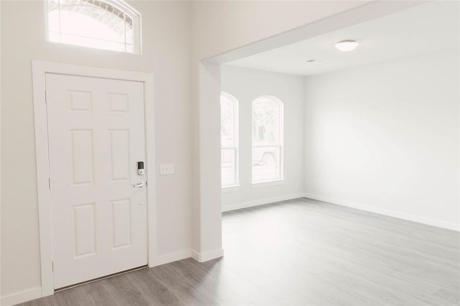 Entryway with hardwood / wood-style flooring