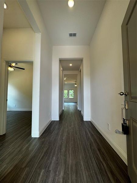 Corridor featuring dark hardwood / wood-style floors