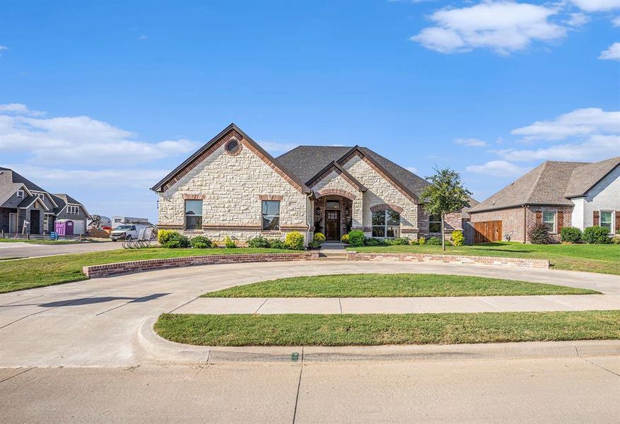 French country inspired facade featuring a front yard