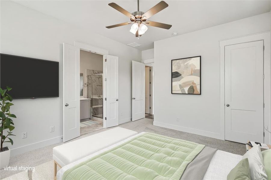 Bedroom featuring ceiling fan, light colored carpet, and connected bathroom