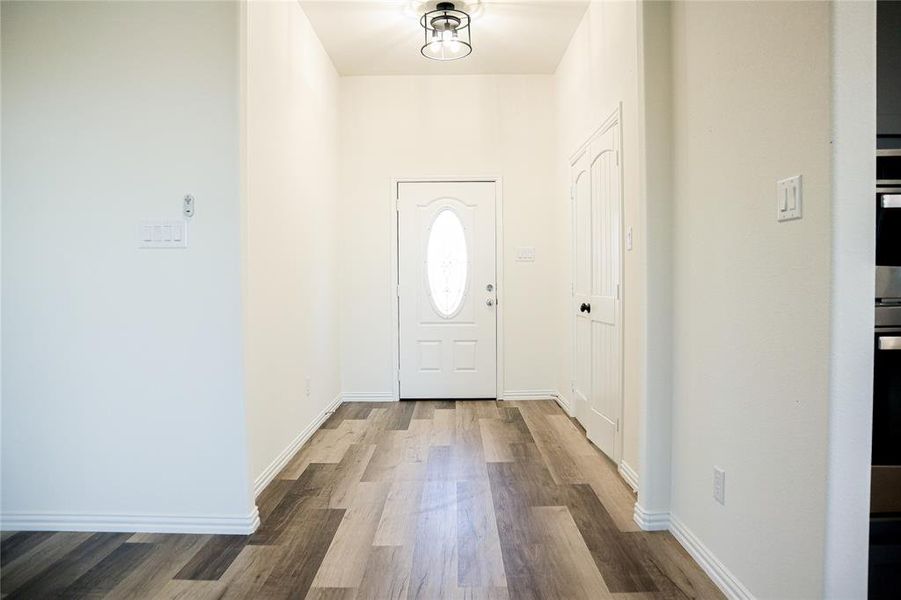 Foyer entrance with hardwood / wood-style floors