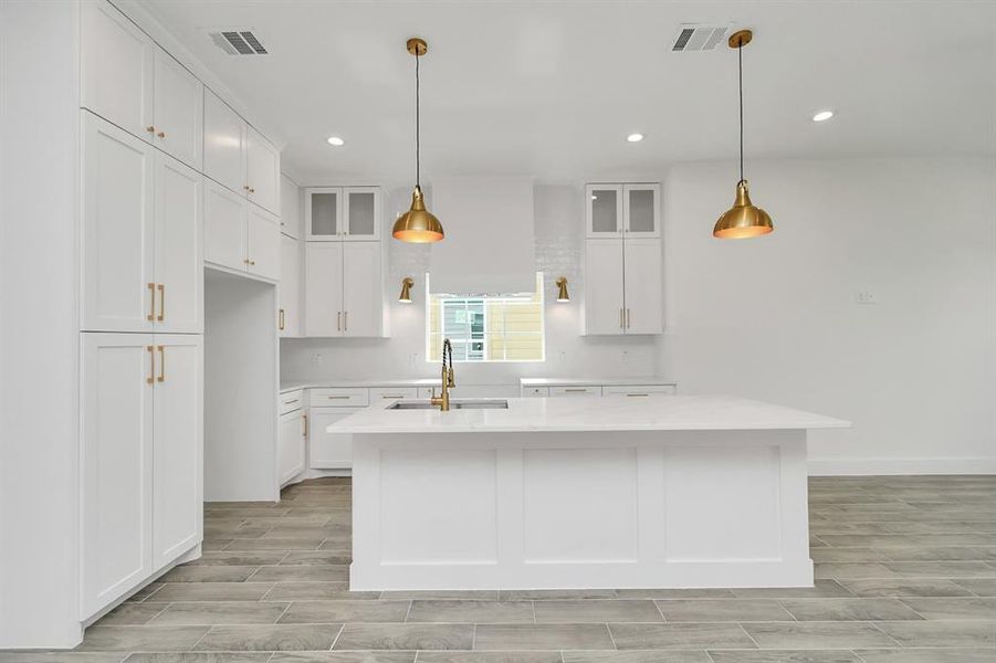 Stunner of a kitchen! 11172 Fieldcrest drive offers white shaker cabinets, quartz countertops and custom trim accents on the island - completely one of a kind from floor to ceiling and lovely gold fixtures for a completely high-end finish!